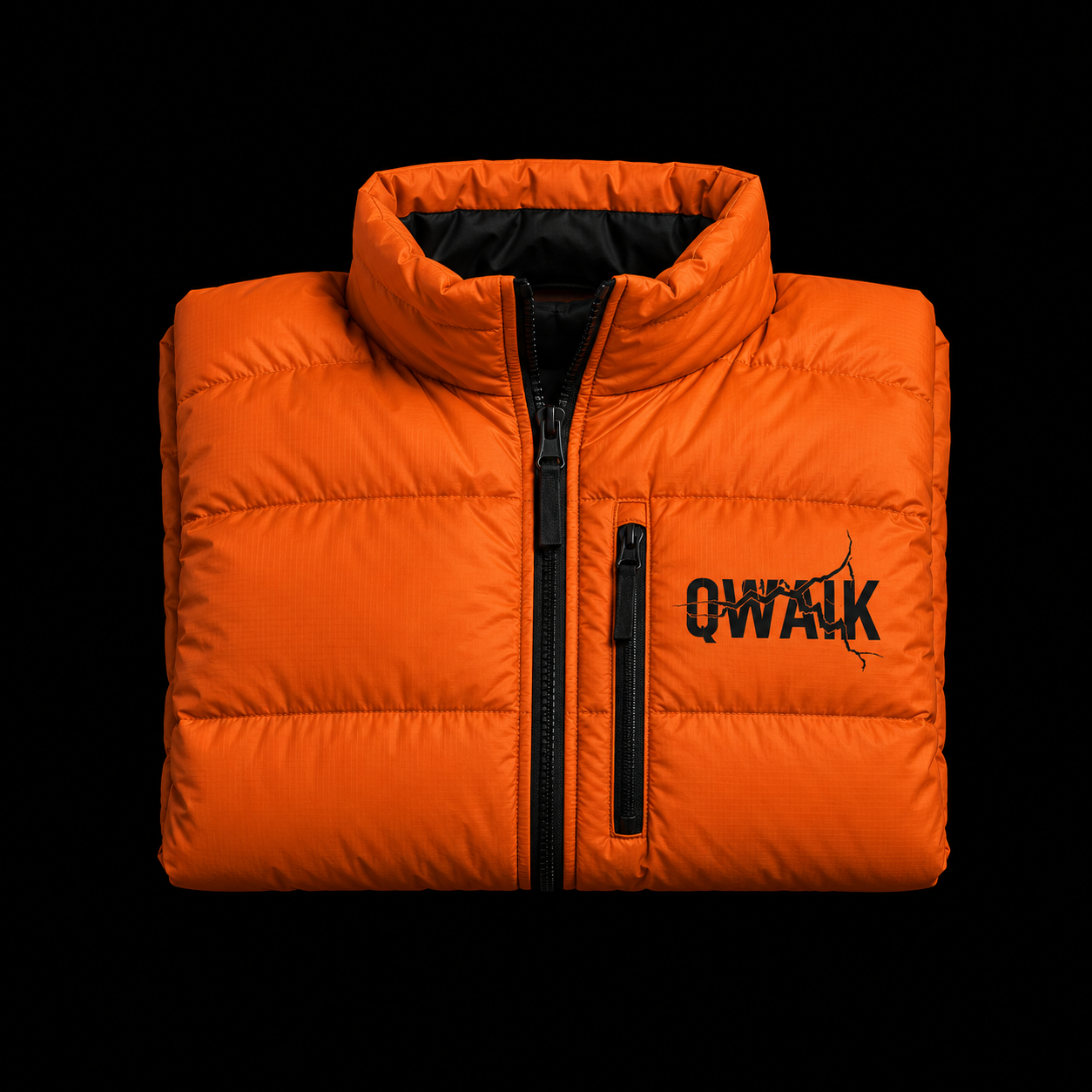 Orange technical jacket with a black QWAIK badge on black diamond-plate